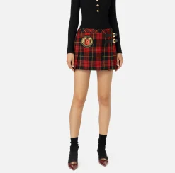 Minigonna a pieghe in lana tartan con patch ricamato