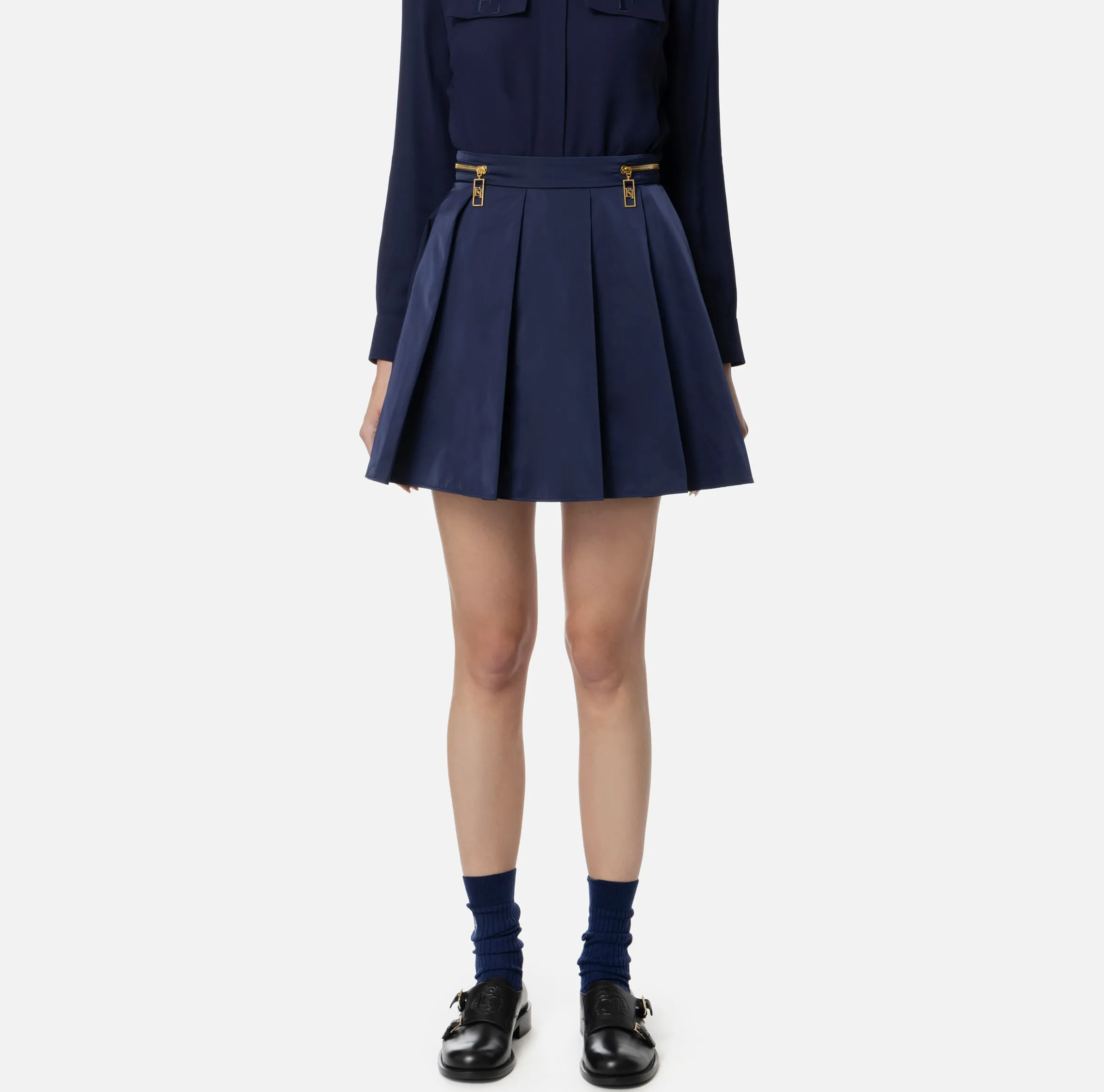 Minigonna a pieghe in nylon tecnico con zip