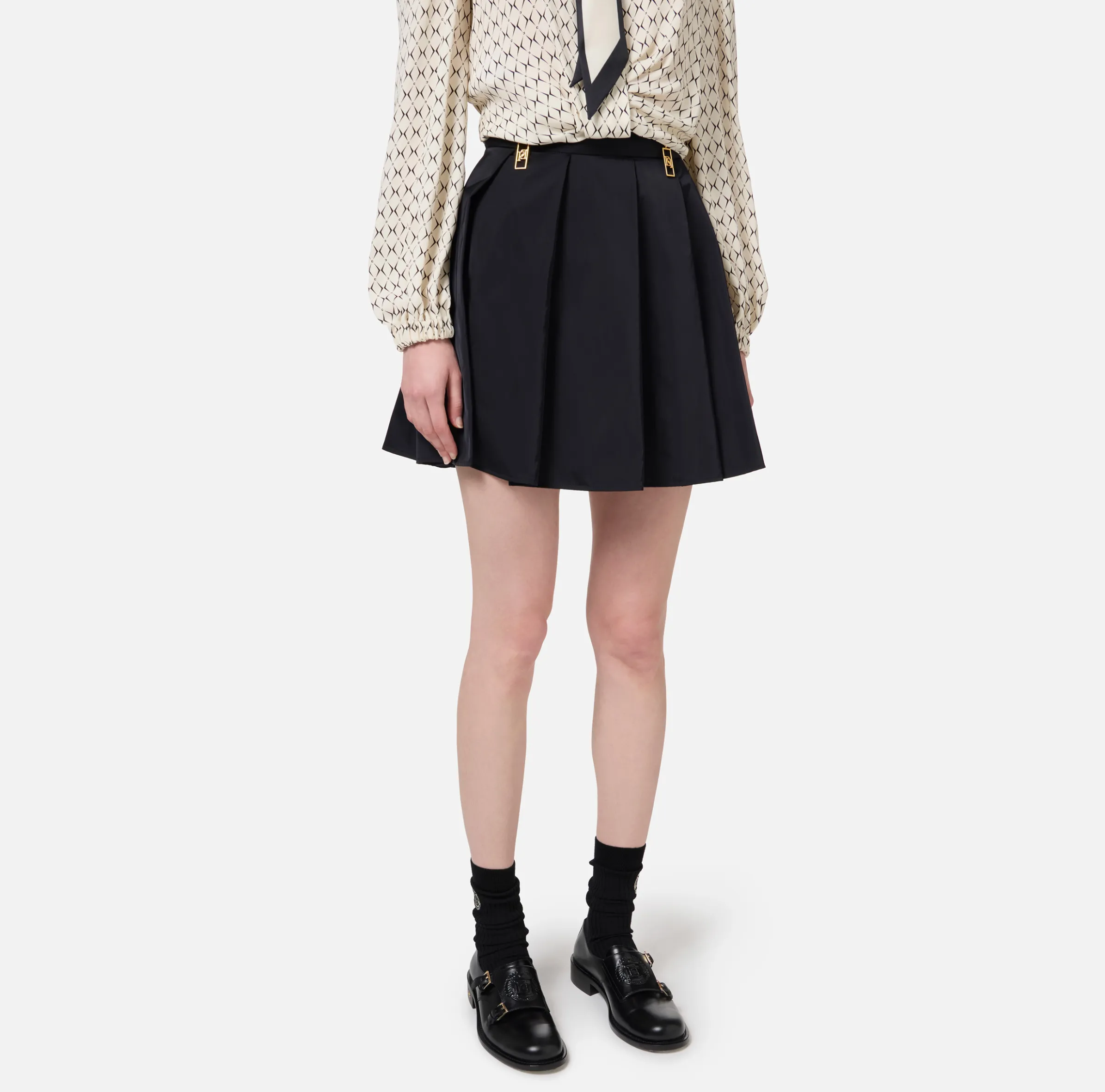 Minigonna a pieghe in nylon tecnico con zip