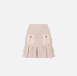 Minigonna in lana bouclé con tasche in vela tecnica