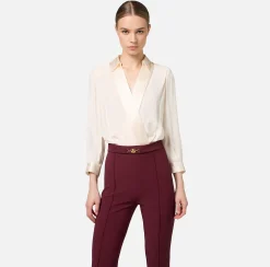 Tuta in viscosa con camicia incrociata e pantalone svasato con morsetto